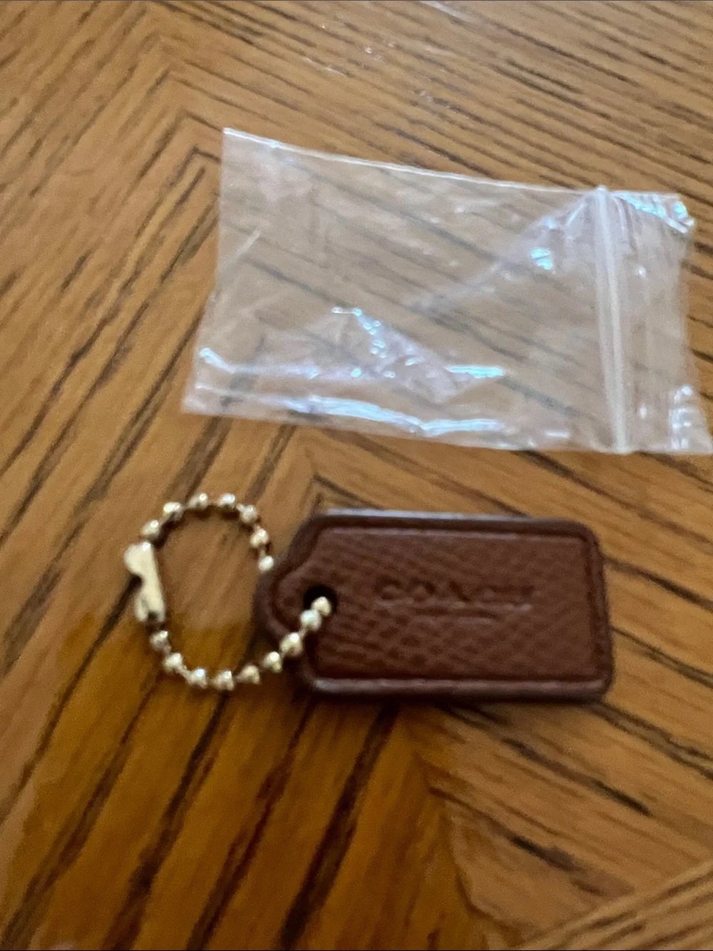 Coach Brown Pebbled Leather Key Tag with gold Bead Chain